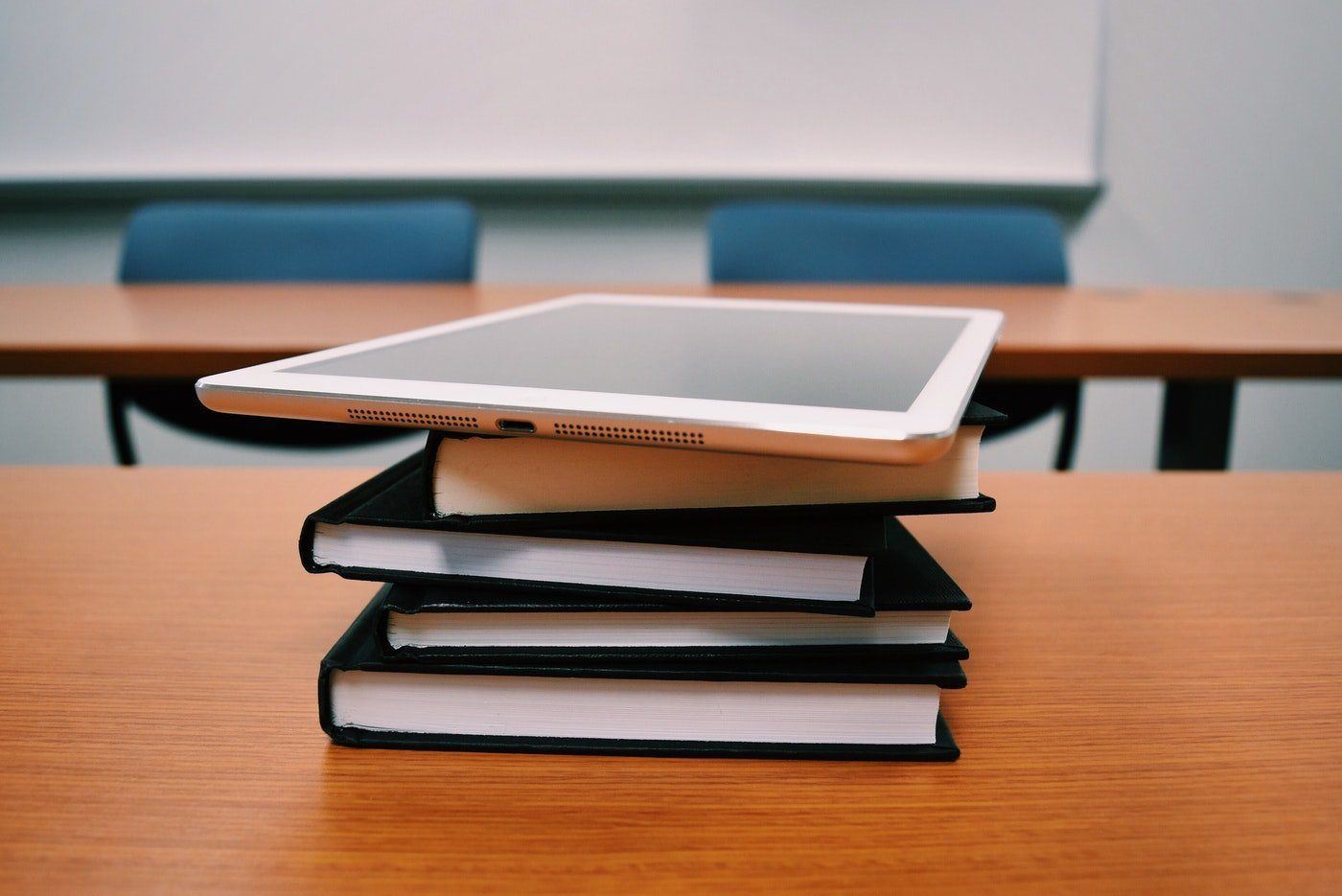Books and tablet on desk - what an engineering student needs to know about renewable energy