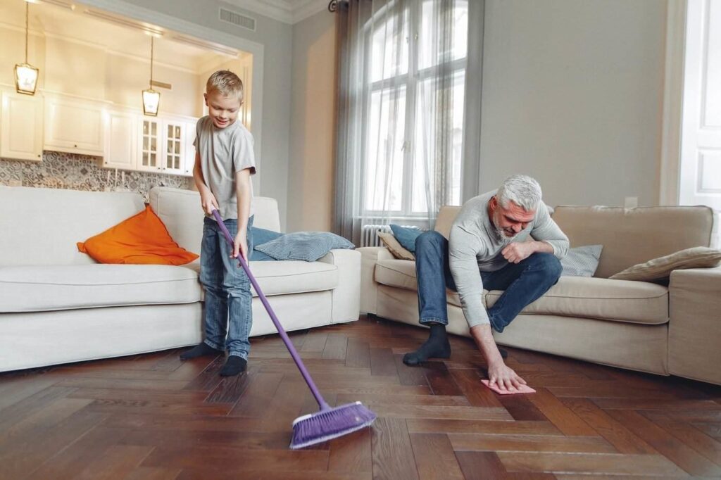 Man and boy cleaning floor - how to stay green while home cleaning