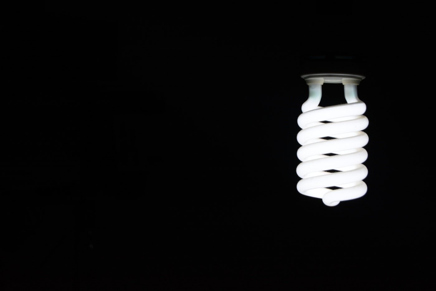 Led bulb on black background - energy saving tips for businesses