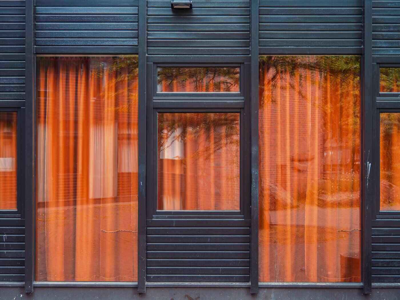Front of home with windows and orange curtains - modular homes in canada