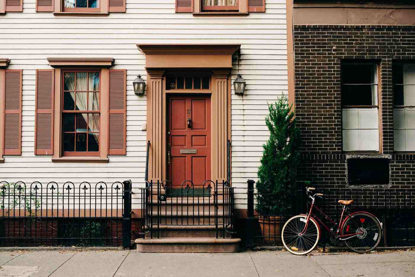 Townhouse with tree and bicycle out front - 6 ways to make your home more sustainable