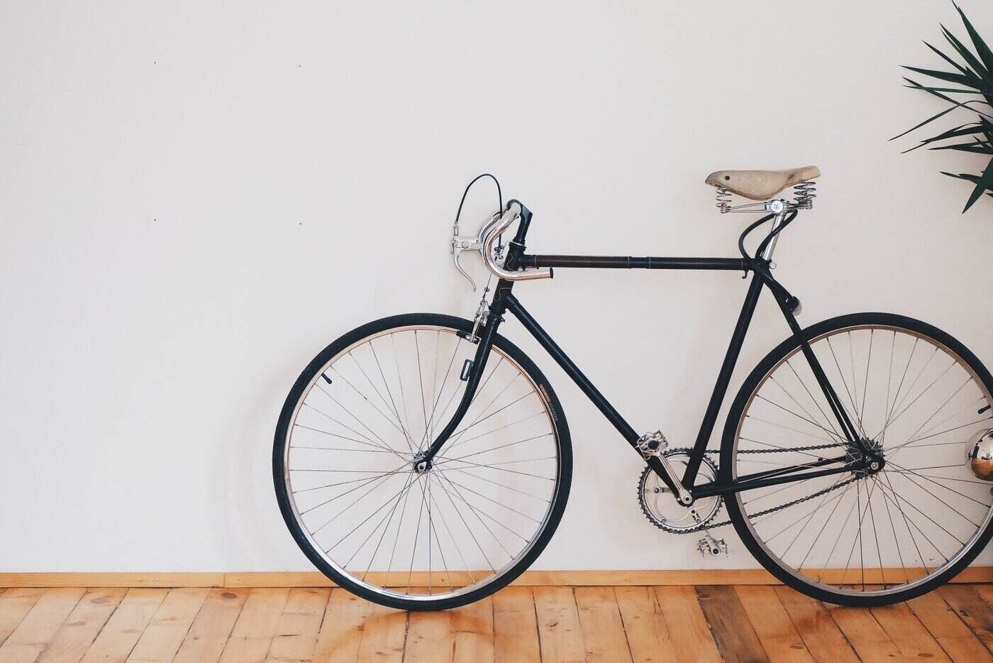 Bicycle leaning against wall on wooden floor - eco-friendly flooring options that might interest you