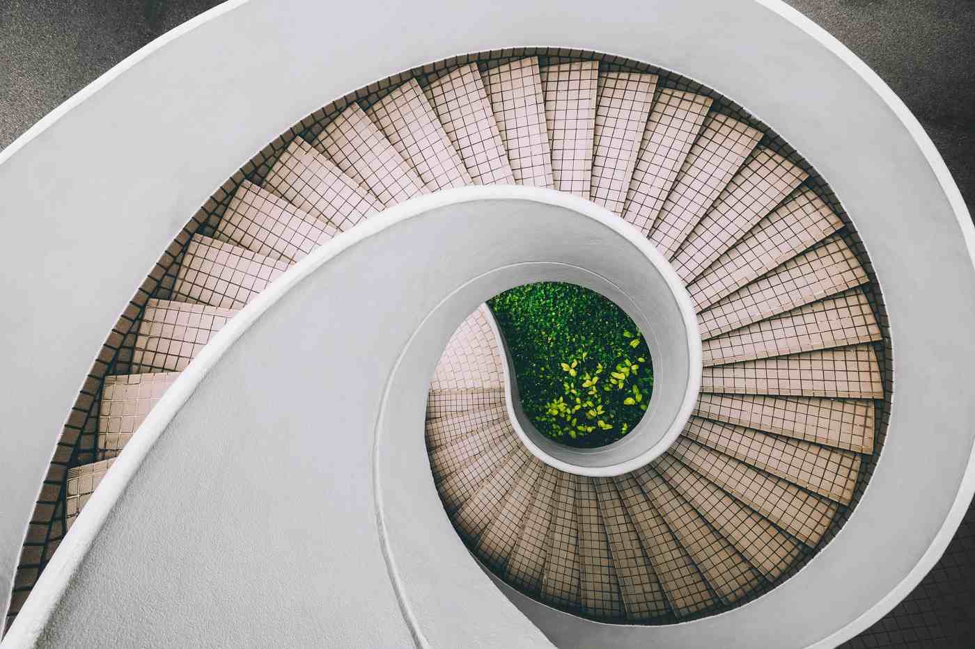 Spiral staircase with greenery at bottom - the futuristic world of living building materials
