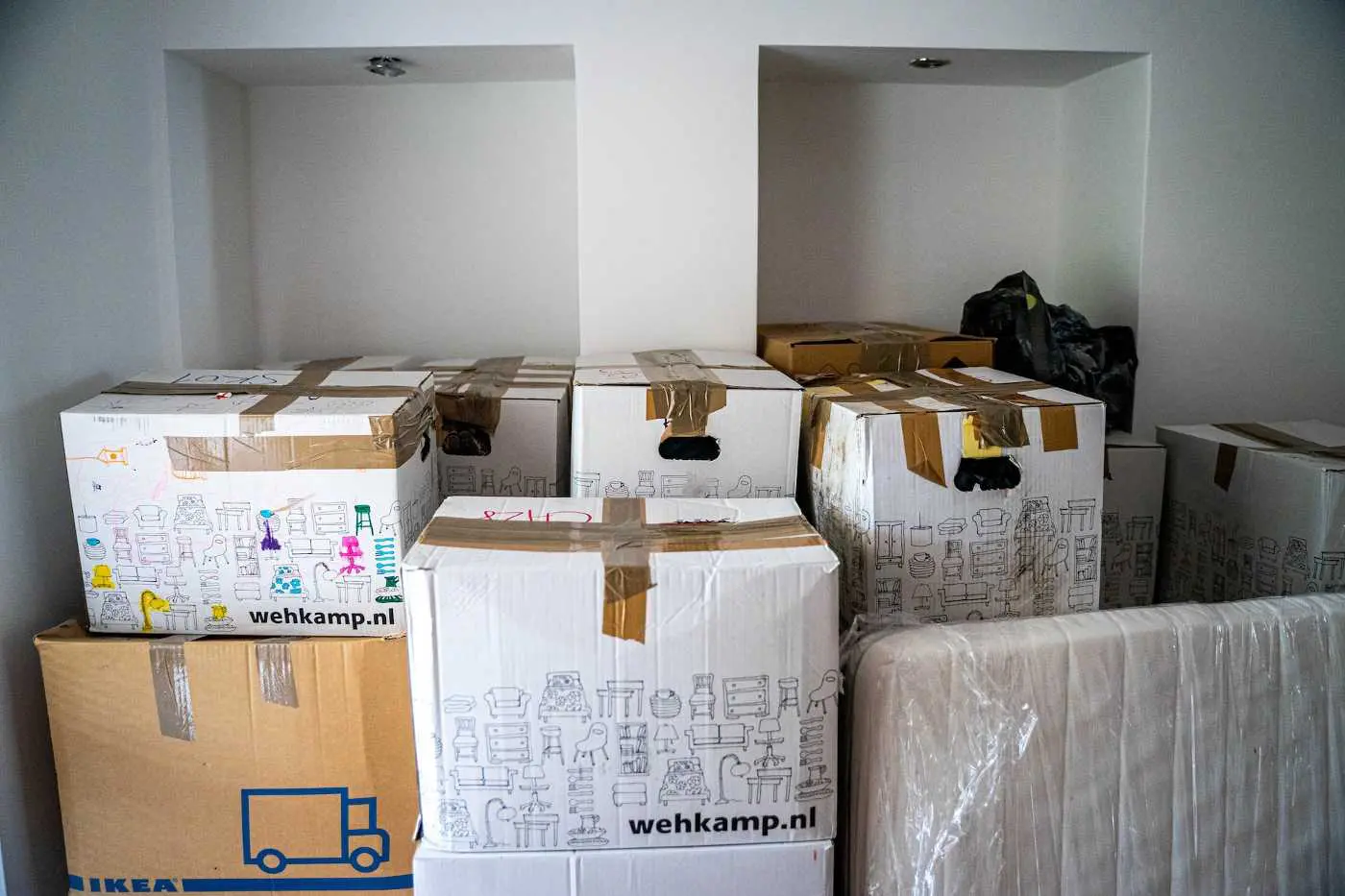 Room packed with moving boxes - sustainable moving us to canada