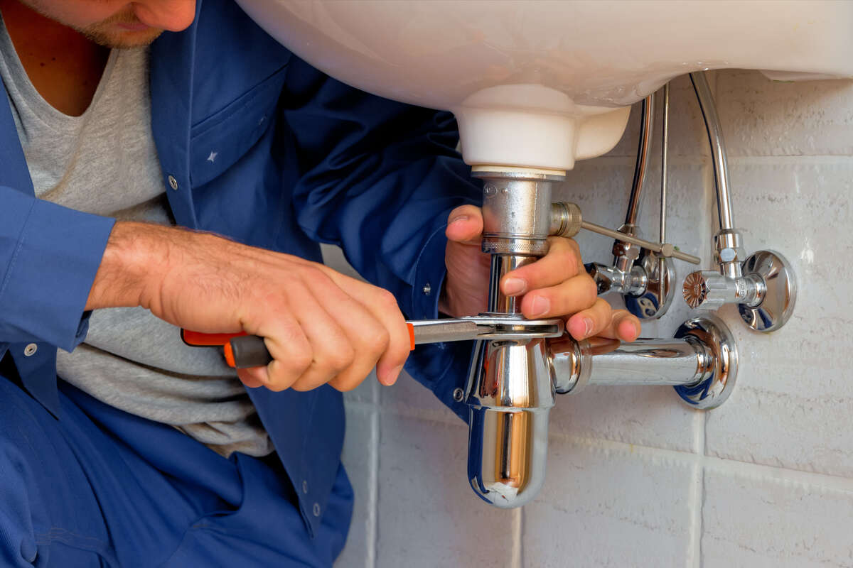 Plumber fixing a sink