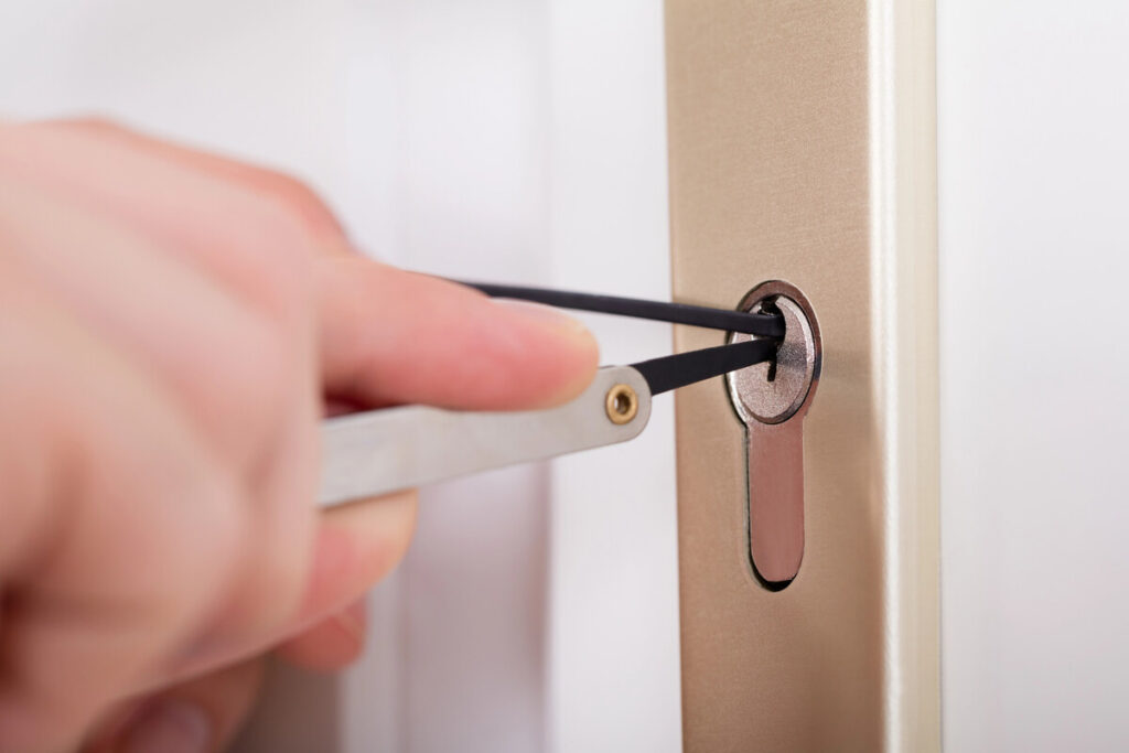 How Much Does A Locksmith Cost In Canada? 5 Locksmith picking door lock of house