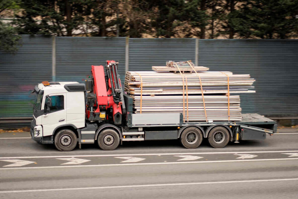 How Building Companies Can Audit Their Logistics Operations For Environmental Performance 1 Pipes - construction supplies on truck