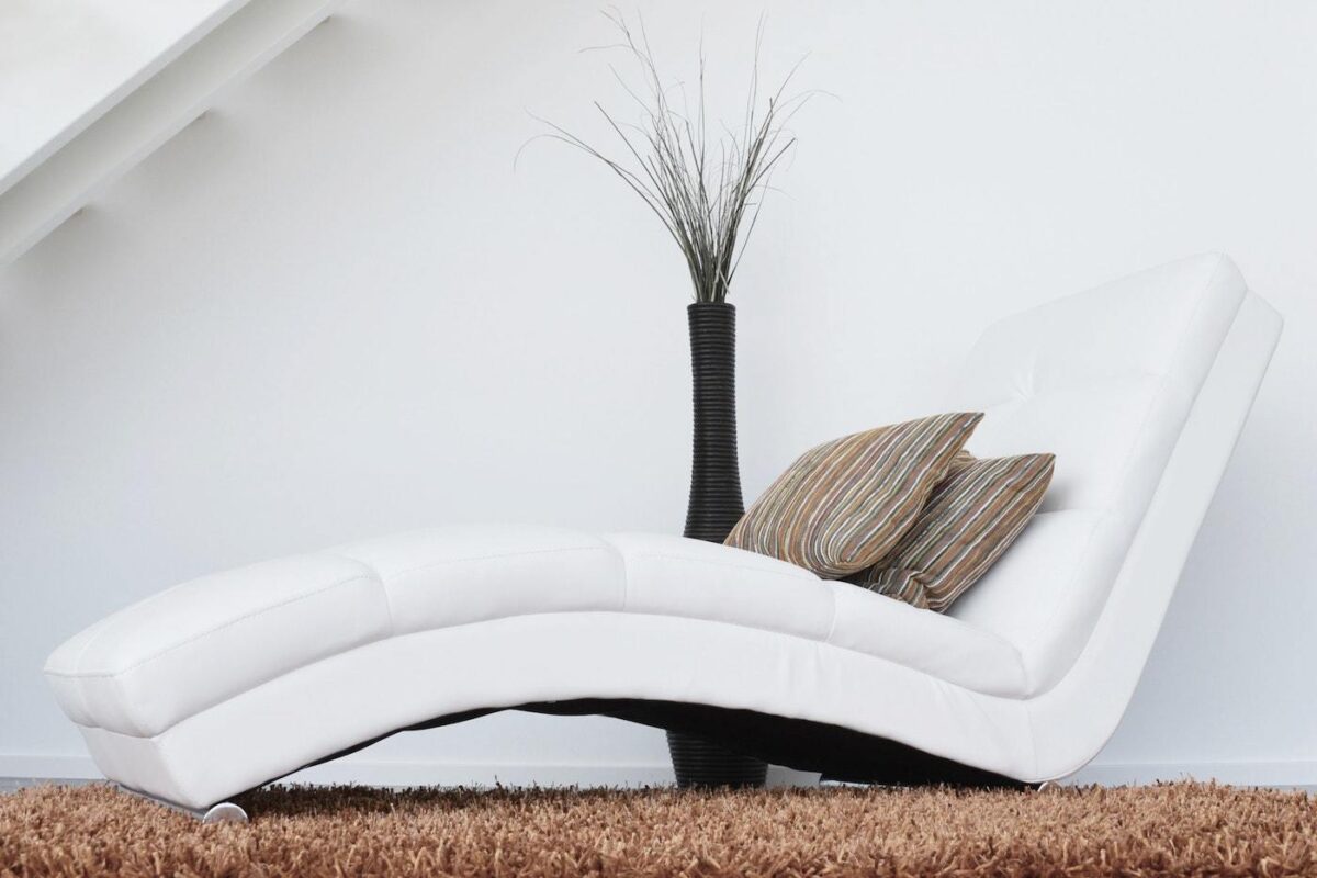 White chaise on brown carpet - eco-friendly carpeting